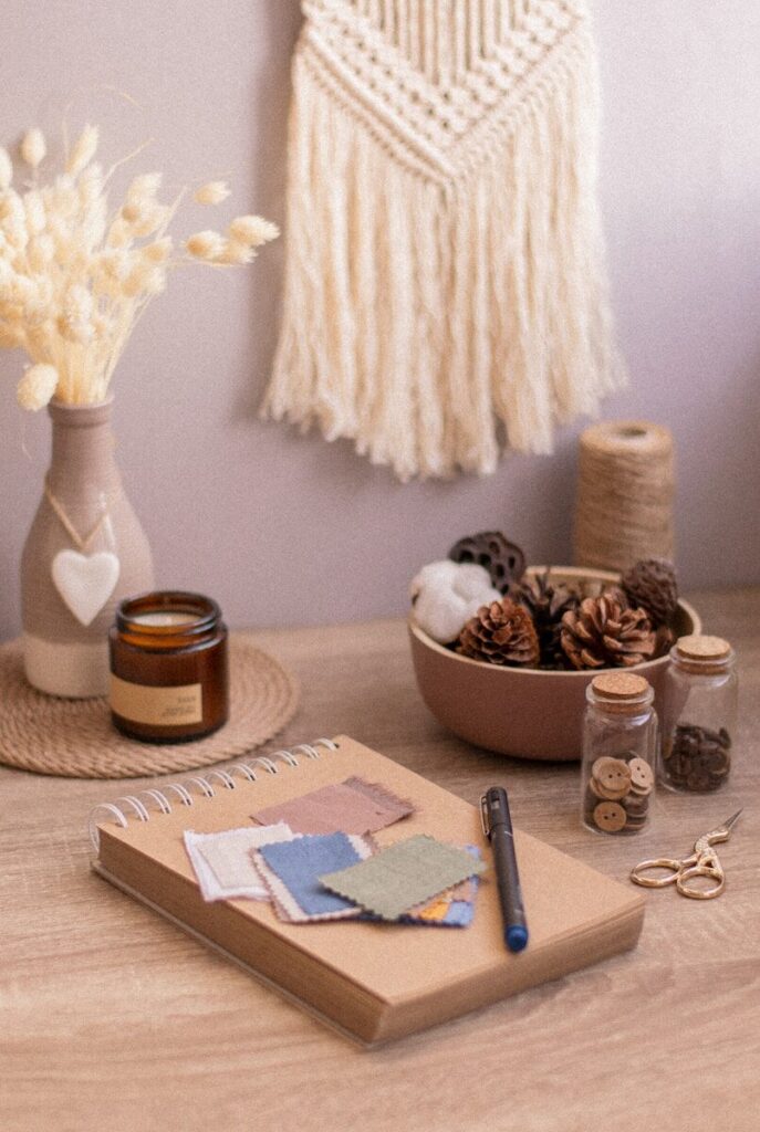 white and brown ceramic mug beside blue and white click pen on brown wooden table